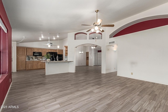 7839 E Milagro Ave, Mesa, AZ 85209 - unfurnished living room with ceiling fan, arched walkways, lofted ceiling, and light wood-style floors