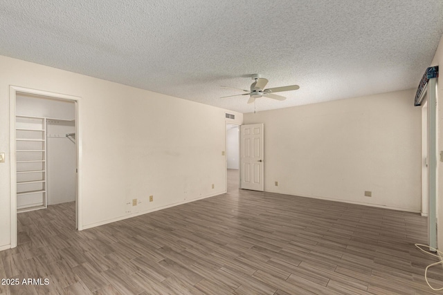 7839 E Milagro Ave, Mesa, AZ 85209 - empty room featuring a ceiling fan, wood finished floors, and a textured ceiling