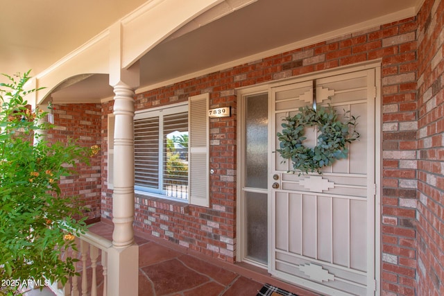 7839 E Milagro Ave, Mesa, AZ 85209 - view of exterior entry featuring brick siding and covered porch