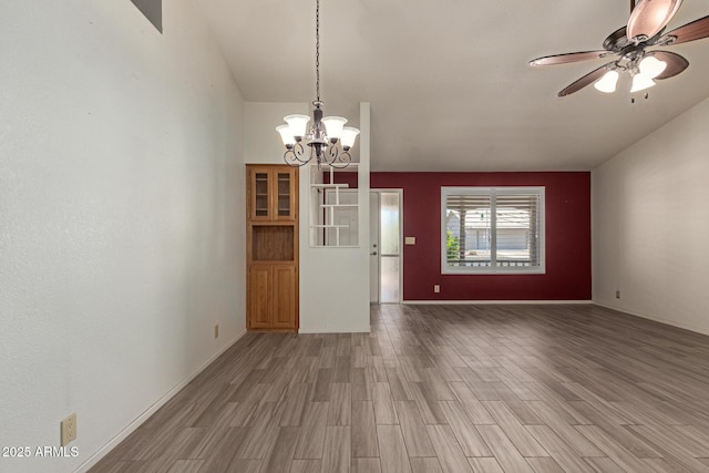 7839 E Milagro Ave, Mesa, AZ 85209 - spare room featuring light wood-type flooring, a chandelier, ceiling fan, and vaulted ceiling