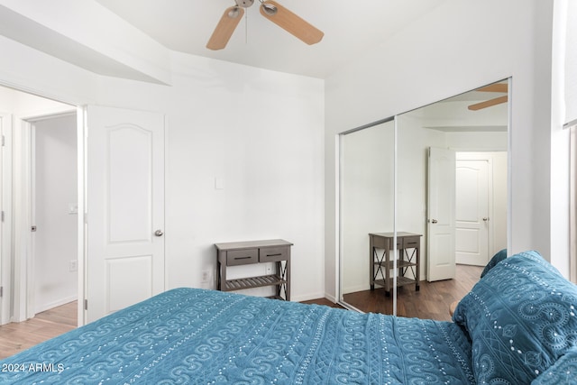 bedroom featuring dark hardwood / wood-style flooring, a closet, and ceiling fan