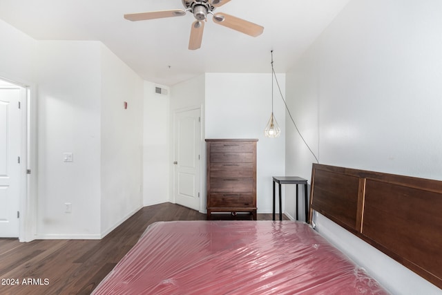 unfurnished bedroom featuring dark hardwood / wood-style floors and ceiling fan