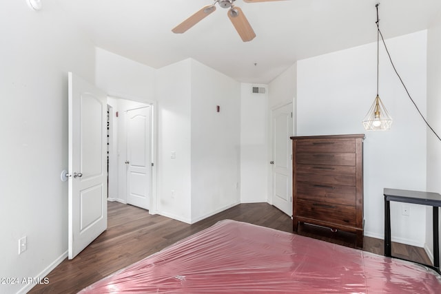 unfurnished bedroom featuring ceiling fan and dark hardwood / wood-style flooring