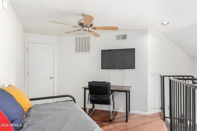 bedroom with hardwood / wood-style flooring, ceiling fan, and lofted ceiling