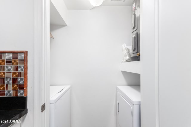 clothes washing area featuring independent washer and dryer