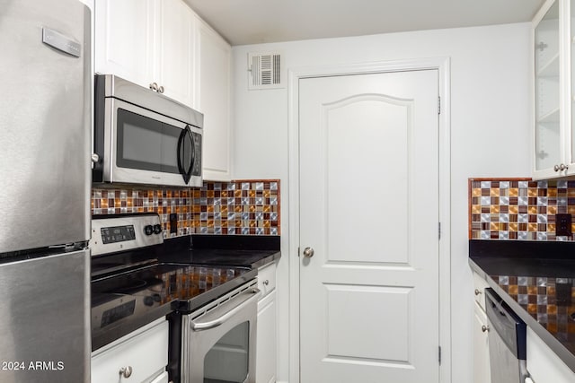 kitchen featuring appliances with stainless steel finishes, tasteful backsplash, and white cabinetry