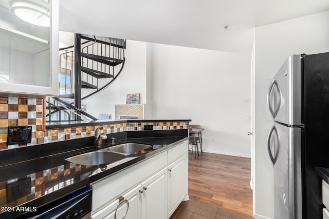 kitchen with backsplash, stainless steel appliances, sink, white cabinets, and dark hardwood / wood-style floors