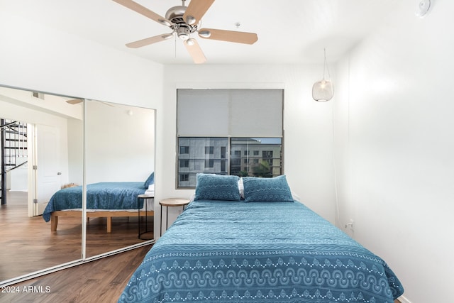 bedroom with ceiling fan, a closet, and hardwood / wood-style flooring