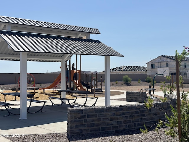 view of patio / terrace with playground community and fence