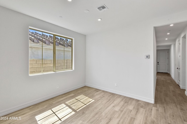 unfurnished room with light wood-type flooring