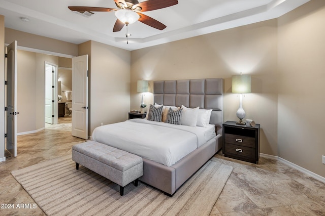 bedroom with a tray ceiling and ceiling fan