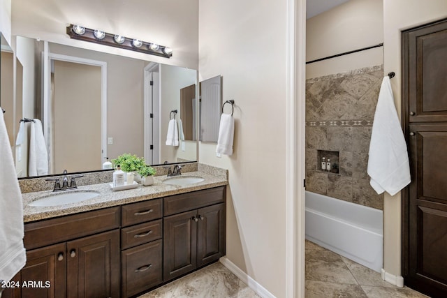 bathroom featuring vanity and tiled shower / bath combo