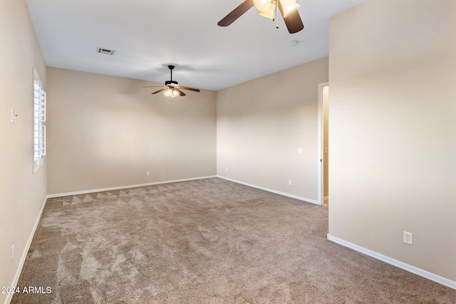 carpeted empty room featuring ceiling fan