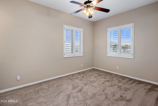 unfurnished room featuring carpet flooring, ceiling fan, and plenty of natural light