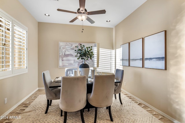 dining room featuring plenty of natural light, ceiling fan, and light colored carpet