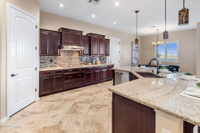 kitchen featuring sink, light stone countertops, an inviting chandelier, decorative light fixtures, and stainless steel dishwasher