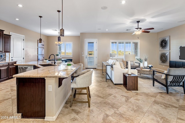 kitchen featuring a large island, plenty of natural light, sink, and decorative light fixtures