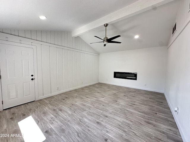 unfurnished living room featuring light hardwood / wood-style floors, lofted ceiling with beams, and ceiling fan