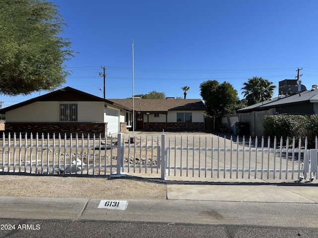 ranch-style home featuring a garage and central AC