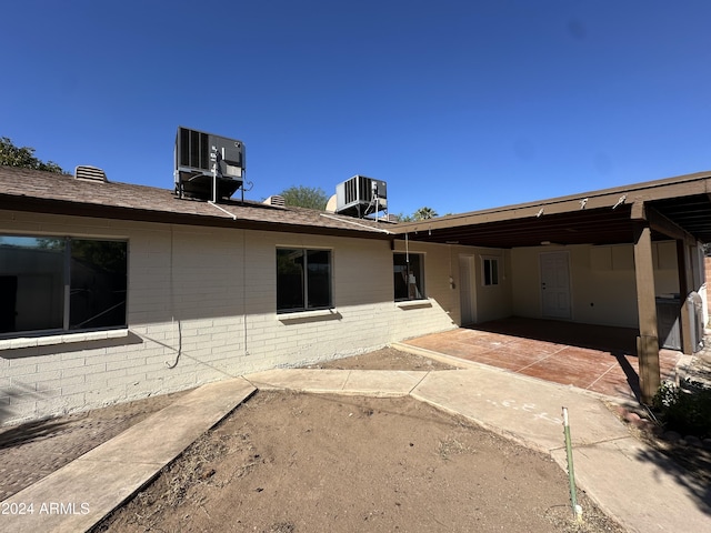 back of house with cooling unit and a patio area