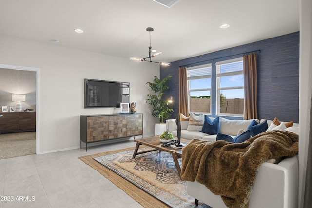 living area with baseboards, recessed lighting, and a chandelier