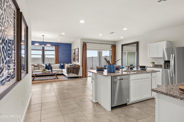 kitchen featuring stainless steel appliances, a sink, white cabinets, light stone counters, and recessed lighting