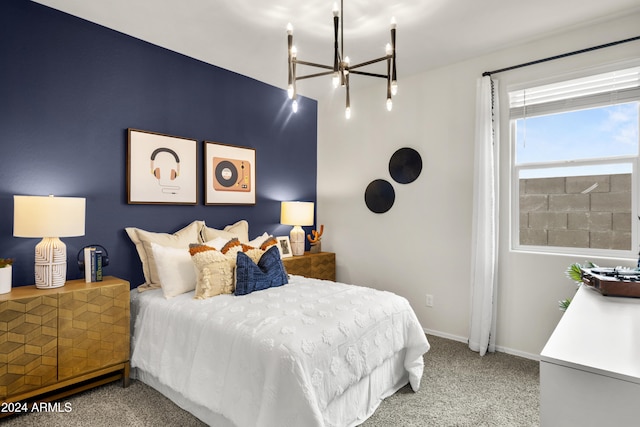 bedroom featuring a chandelier, carpet floors, and baseboards