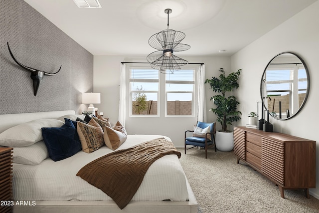 bedroom with a chandelier, carpet, and multiple windows