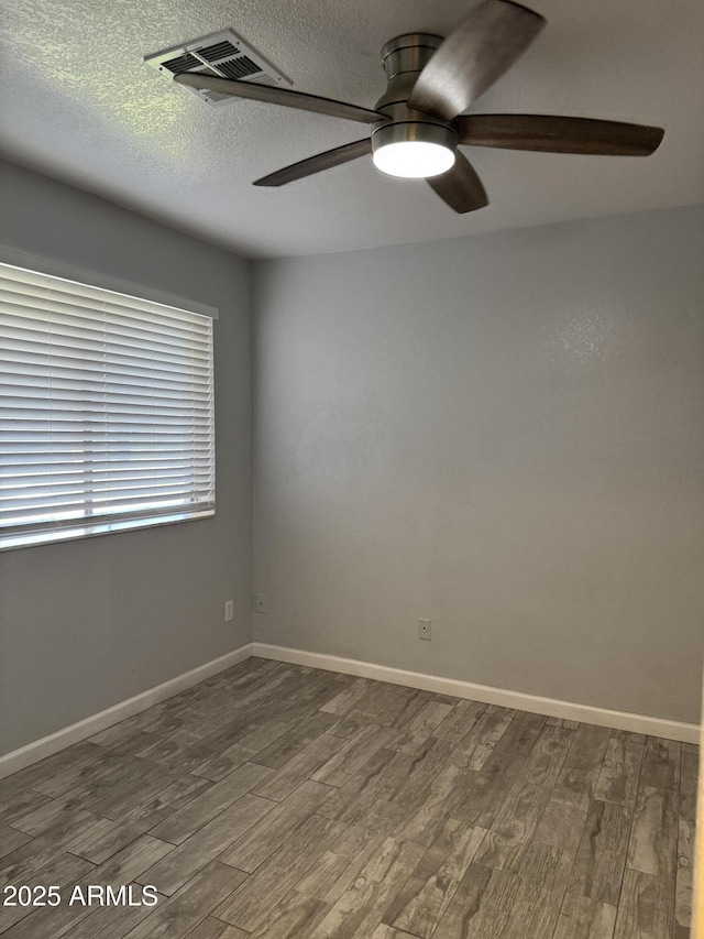 8101 N 107th Ave Unit 26, Peoria, AZ 85345 - spare room featuring wood finished floors, ceiling fan, baseboards, and a textured ceiling