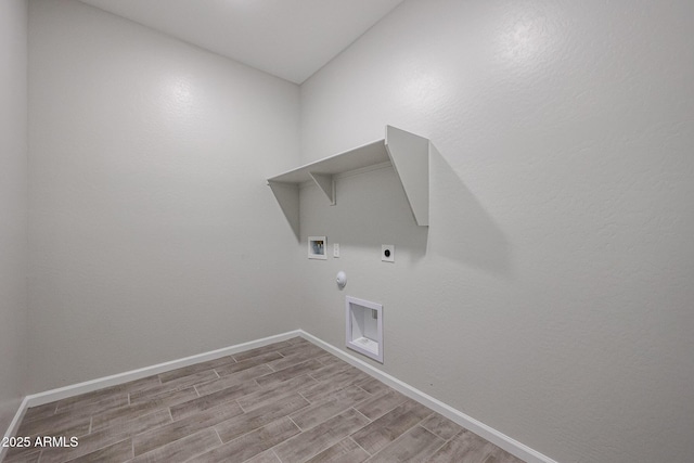 1917 S 246th Ln, Buckeye, AZ 85326 - clothes washing area with light wood finished floors, baseboards, electric dryer hookup, gas dryer hookup, and laundry area