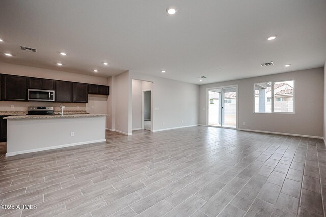 1917 S 246th Ln, Buckeye, AZ 85326 - unfurnished living room with recessed lighting, visible vents, and baseboards