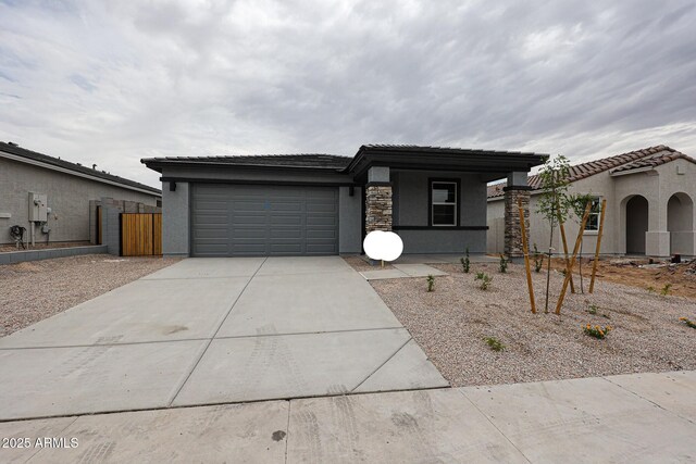 1917 S 246th Ln, Buckeye, AZ 85326 - view of front of home with driveway, a tiled roof, fence, a garage, and stucco siding