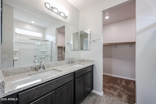1917 S 246th Ln, Buckeye, AZ 85326 - bathroom with a spacious closet, a sink, and a stall shower