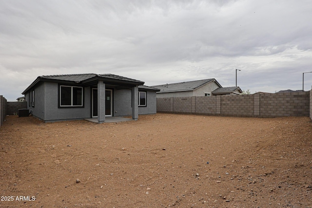 1917 S 246th Ln, Buckeye, AZ 85326 - rear view of house featuring stucco siding, a fenced backyard, a tiled roof, and a patio