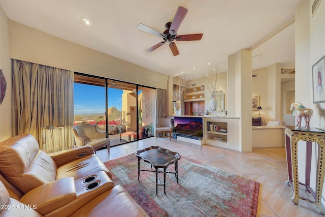 living room with ceiling fan and built in features