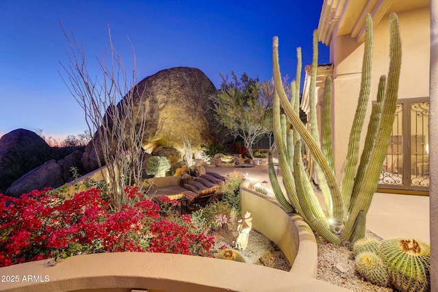 yard at dusk featuring a mountain view