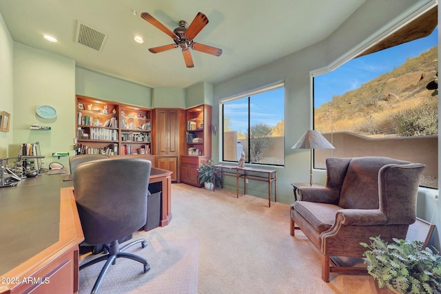 office space with ceiling fan and light colored carpet