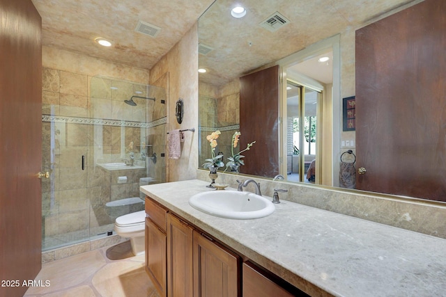 bathroom with tile patterned flooring, vanity, toilet, and a shower with shower door