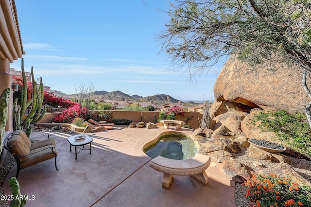 view of patio / terrace featuring a mountain view and a jacuzzi