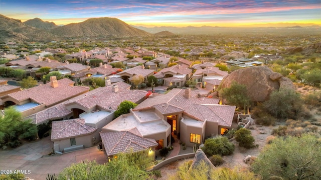 aerial view at dusk featuring a mountain view