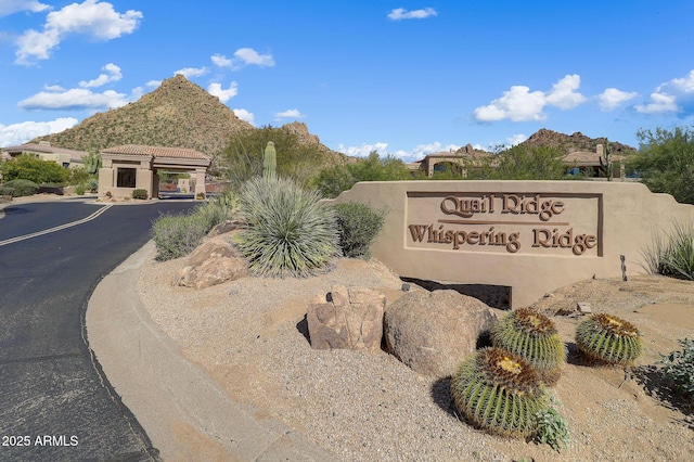 community sign with a mountain view