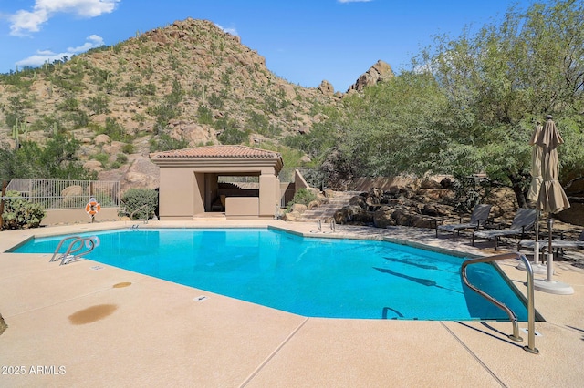 view of pool featuring a mountain view and a patio