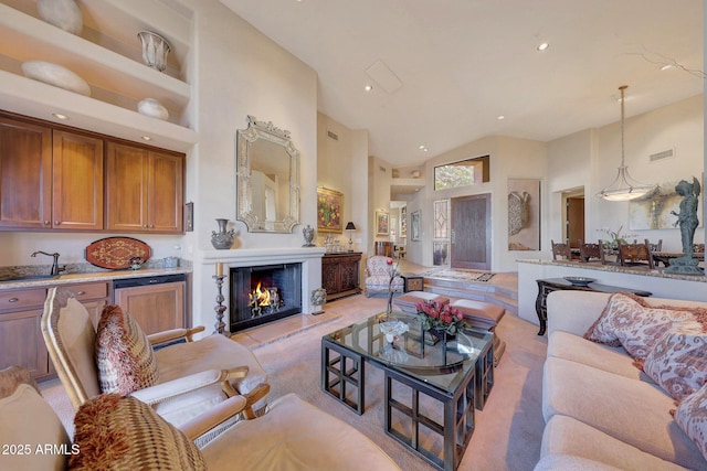 living room with built in features, high vaulted ceiling, and sink