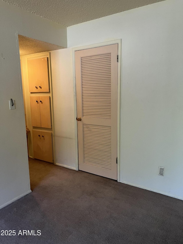 2530 W Berridge Ln Unit E111, Phoenix, AZ 85017 - carpeted empty room with a textured ceiling