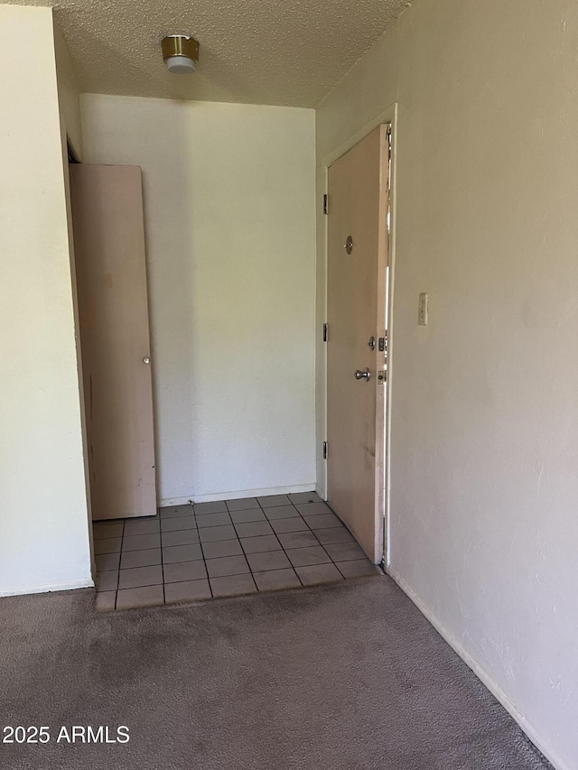 2530 W Berridge Ln Unit E111, Phoenix, AZ 85017 - tiled spare room featuring carpet floors and a textured ceiling