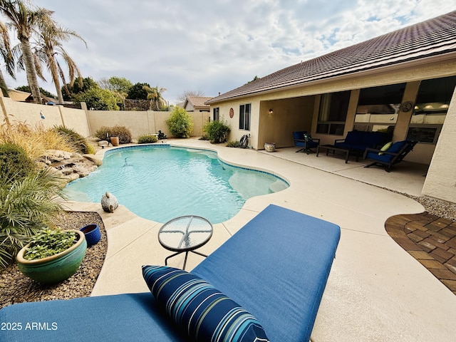 view of swimming pool featuring an outdoor living space and a patio