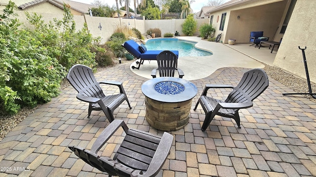 view of pool with a patio area and an outdoor fire pit