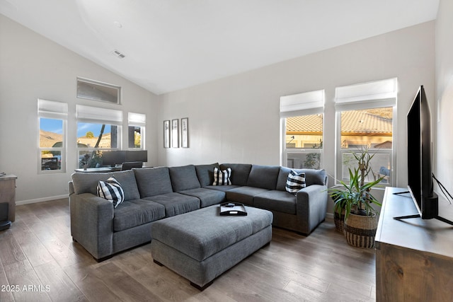 living room with wood-type flooring and high vaulted ceiling