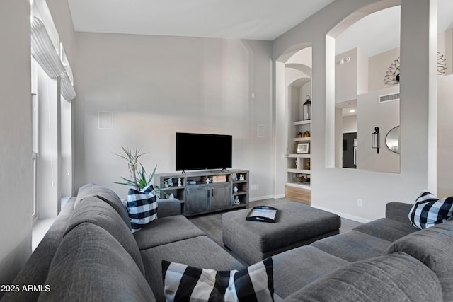 living room with hardwood / wood-style flooring and built in features