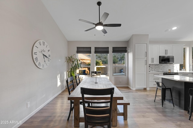 dining area featuring ceiling fan and light wood-type flooring